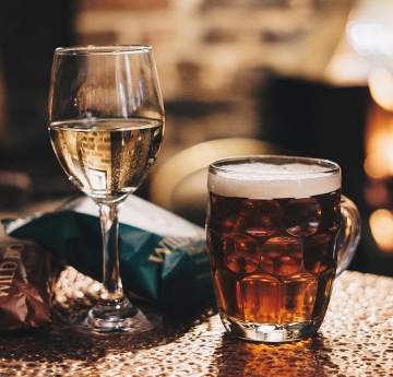 A glass of wine and beer on a table